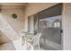 A cozy outdoor balcony setup with a table and chairs, perfect for relaxing or enjoying a meal at 4554 E Paradise Village N Pkwy # 249, Phoenix, AZ 85032