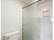 A clean bathroom with a toilet and enclosed shower, featuring sliding glass doors and marble-look shower surround at 4554 E Paradise Village N Pkwy # 249, Phoenix, AZ 85032