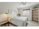 Light and bright bedroom with ceiling fan, bookcase, and gray-toned flooring at 4554 E Paradise Village N Pkwy # 249, Phoenix, AZ 85032