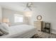 Inviting bedroom with a ceiling fan, wood-look floors, and natural light at 4554 E Paradise Village N Pkwy # 249, Phoenix, AZ 85032