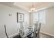 Dining area with overhead lighting looks onto an exterior window and wall art at 4554 E Paradise Village N Pkwy # 249, Phoenix, AZ 85032