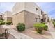Exterior corner of home features neutral color palette and simple landscaping, providing a neat and tidy appearance at 4554 E Paradise Village N Pkwy # 249, Phoenix, AZ 85032