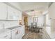 Bright kitchen with white cabinetry and appliances looks into dining area at 4554 E Paradise Village N Pkwy # 249, Phoenix, AZ 85032