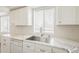 Bright kitchen features white cabinetry, stainless steel sink, white appliances and light countertops at 4554 E Paradise Village N Pkwy # 249, Phoenix, AZ 85032
