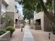 Scenic walkway between buildings in a community featuring desert landscaping at 4554 E Paradise Village N Pkwy # 249, Phoenix, AZ 85032