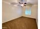 Bedroom with carpet floors, ceiling fan, and window with white shutter style blinds at 4643 N Clear Creek Dr, Litchfield Park, AZ 85340