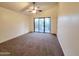 Bedroom featuring a ceiling fan, carpet flooring, and sliding glass doors to the backyard at 4643 N Clear Creek Dr, Litchfield Park, AZ 85340