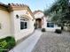 Charming home exterior featuring a well-maintained walkway, neutral stucco, and lovely desert landscaping at 4643 N Clear Creek Dr, Litchfield Park, AZ 85340