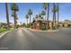 Community guard house surrounded by palm trees and a well manicured circle driveway at 4643 N Clear Creek Dr, Litchfield Park, AZ 85340