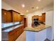 Well-lit kitchen featuring granite countertops, wooden cabinetry, and modern appliances at 4643 N Clear Creek Dr, Litchfield Park, AZ 85340
