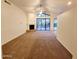 Spacious living room featuring vaulted ceilings, a fireplace, and plush carpeting at 4643 N Clear Creek Dr, Litchfield Park, AZ 85340