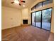 Bright living room with cozy fireplace, ceiling fan, and large sliding glass doors at 4643 N Clear Creek Dr, Litchfield Park, AZ 85340