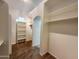 Spacious walk-in closet with carpet floor, shelving, and archway for bathroom access at 4643 N Clear Creek Dr, Litchfield Park, AZ 85340