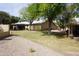 Spacious backyard featuring mature trees, lush lawn, and a gravel walkway at 4773 E Hopi St, Phoenix, AZ 85044