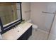 Modern bathroom featuring a blue vanity, updated fixtures, and tiled flooring at 4773 E Hopi St, Phoenix, AZ 85044