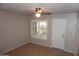 Bedroom featuring a ceiling fan, tile floors, and a window with plantation shutters at 4773 E Hopi St, Phoenix, AZ 85044