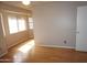 Bedroom with wood floors, ceiling fan, and door leading to a hall with additional bedrooms at 4773 E Hopi St, Phoenix, AZ 85044