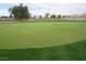 Lush green golf course with a red flag marking the hole, providing a scenic and recreational amenity at 4773 E Hopi St, Phoenix, AZ 85044