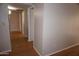 Hallway with wood-look flooring leading to various rooms in the home at 4773 E Hopi St, Phoenix, AZ 85044
