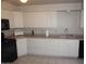 Traditional kitchen features white cabinets, neutral countertops, and essential appliances at 4773 E Hopi St, Phoenix, AZ 85044