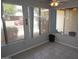 Bright sun room with tile flooring and large windows overlooking the landscaped exterior at 4773 E Hopi St, Phoenix, AZ 85044