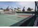 Well-maintained tennis courts, surrounded by lush landscaping, provide a private and active recreational space at 4773 E Hopi St, Phoenix, AZ 85044