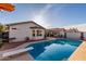 Beautiful backyard with a sparkling pool, diving board, covered patio, and lush landscaping at 5361 N 77Th Ln, Glendale, AZ 85303