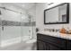 Bathroom showcases a shower-tub combo with a glass screen and vanity at 5361 N 77Th Ln, Glendale, AZ 85303
