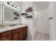 Bathroom features wood cabinets, a granite countertop, and decorative shelving at 5361 N 77Th Ln, Glendale, AZ 85303