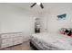 Well-lit bedroom featuring a white dresser, ceiling fan, and comfortable bedding at 5361 N 77Th Ln, Glendale, AZ 85303