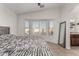 Bedroom with bay window, shutters, tile floor, and access to a bathroom at 5361 N 77Th Ln, Glendale, AZ 85303