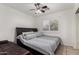 Neutral bedroom showcasing a ceiling fan, window shutters, and comfortable bedding at 5361 N 77Th Ln, Glendale, AZ 85303