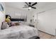 Bright bedroom with a ceiling fan, window, desk, and comfortable bedding at 5361 N 77Th Ln, Glendale, AZ 85303
