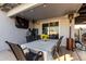 Comfortable covered patio with outdoor seating and a dining area and patio heater at 5361 N 77Th Ln, Glendale, AZ 85303