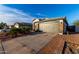 Suburban home featuring a two car garage, desert landscaping and neutral color palette at 5361 N 77Th Ln, Glendale, AZ 85303