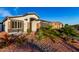 Inviting single-story home highlighting desert landscaping, rocks, and tasteful desert plants at 5361 N 77Th Ln, Glendale, AZ 85303