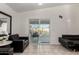 Open living room with tile flooring, sliding glass doors to the pool, and contemporary furnishings at 5361 N 77Th Ln, Glendale, AZ 85303