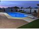 Night view of the pool area with lounge chairs, a diving board, a pergola, and lush landscaping at 5361 N 77Th Ln, Glendale, AZ 85303