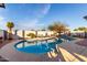 Relaxing pool area featuring a dive, lounge chairs, and lush landscaping creating a serene atmosphere at 5361 N 77Th Ln, Glendale, AZ 85303