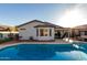Backyard featuring a sparkling pool, covered patio, and manicured landscaping, great for outdoor entertaining at 5361 N 77Th Ln, Glendale, AZ 85303