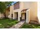 Exterior view of a townhome with a tidy lawn and tiled porch roof at 5741 N 44Th Ln, Glendale, AZ 85301