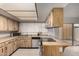 Well-lit kitchen with light wood cabinets, stainless steel appliances, and access to the outside patio at 5741 N 44Th Ln, Glendale, AZ 85301