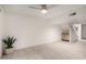 Living room with light tile floors, ceiling fan, and bonus cabinet space at 5741 N 44Th Ln, Glendale, AZ 85301