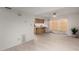 Open-concept living room and kitchen featuring light tile floors and natural wood cabinets at 5741 N 44Th Ln, Glendale, AZ 85301