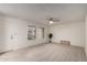 Bright living room with light tile floors, ceiling fan, and sliding glass doors at 5741 N 44Th Ln, Glendale, AZ 85301