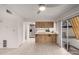 Living room flowing into an updated kitchen featuring light tile floors and stainless appliances at 5741 N 44Th Ln, Glendale, AZ 85301