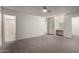 Bright main bedroom featuring carpet, a ceiling fan, access to an ensuite bathroom, and a makeup vanity at 5741 N 44Th Ln, Glendale, AZ 85301