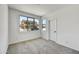 This bedroom has carpet floors, a window with a view of the neighborhood, and a white door at 5875 N 193Rd Dr, Litchfield Park, AZ 85340