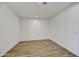A clean and empty room with hardwood-style tile flooring and white walls ready for personalization at 5875 N 193Rd Dr, Litchfield Park, AZ 85340