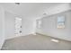 Bright main bedroom with neutral carpet and multiple windows for ample natural light at 5875 N 193Rd Dr, Litchfield Park, AZ 85340